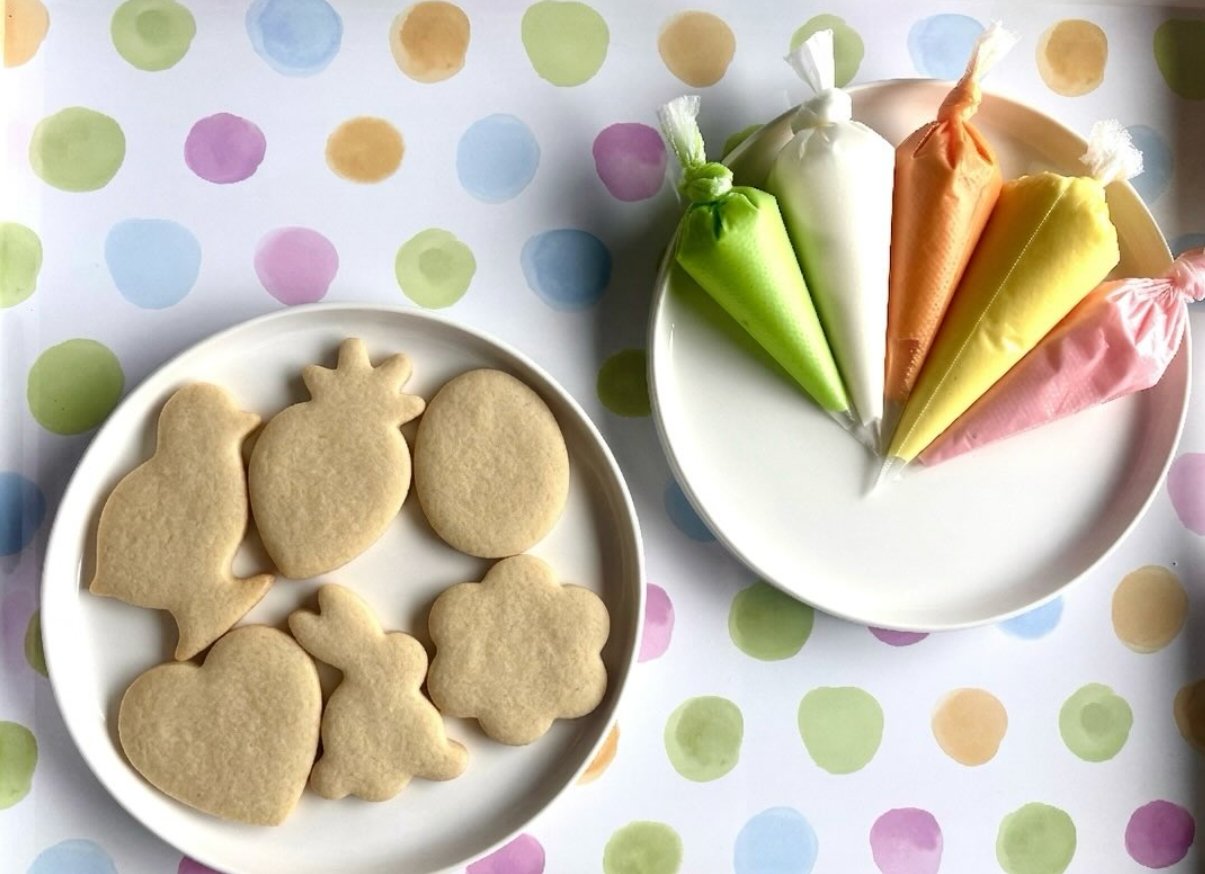 Undecorated Easter sugar cookies with icing bags