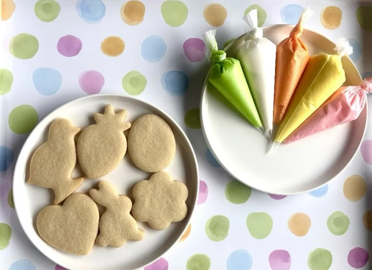 Undecorated Easter sugar cookies with icing bags