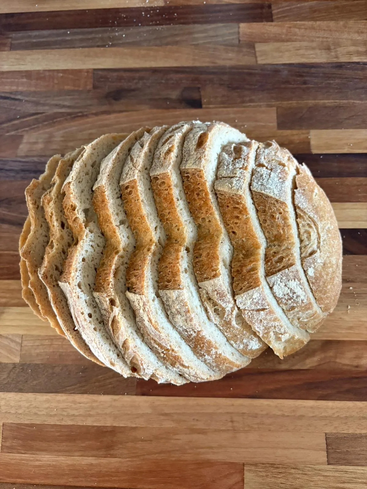 Sliced sourdough fanned out on a wood board